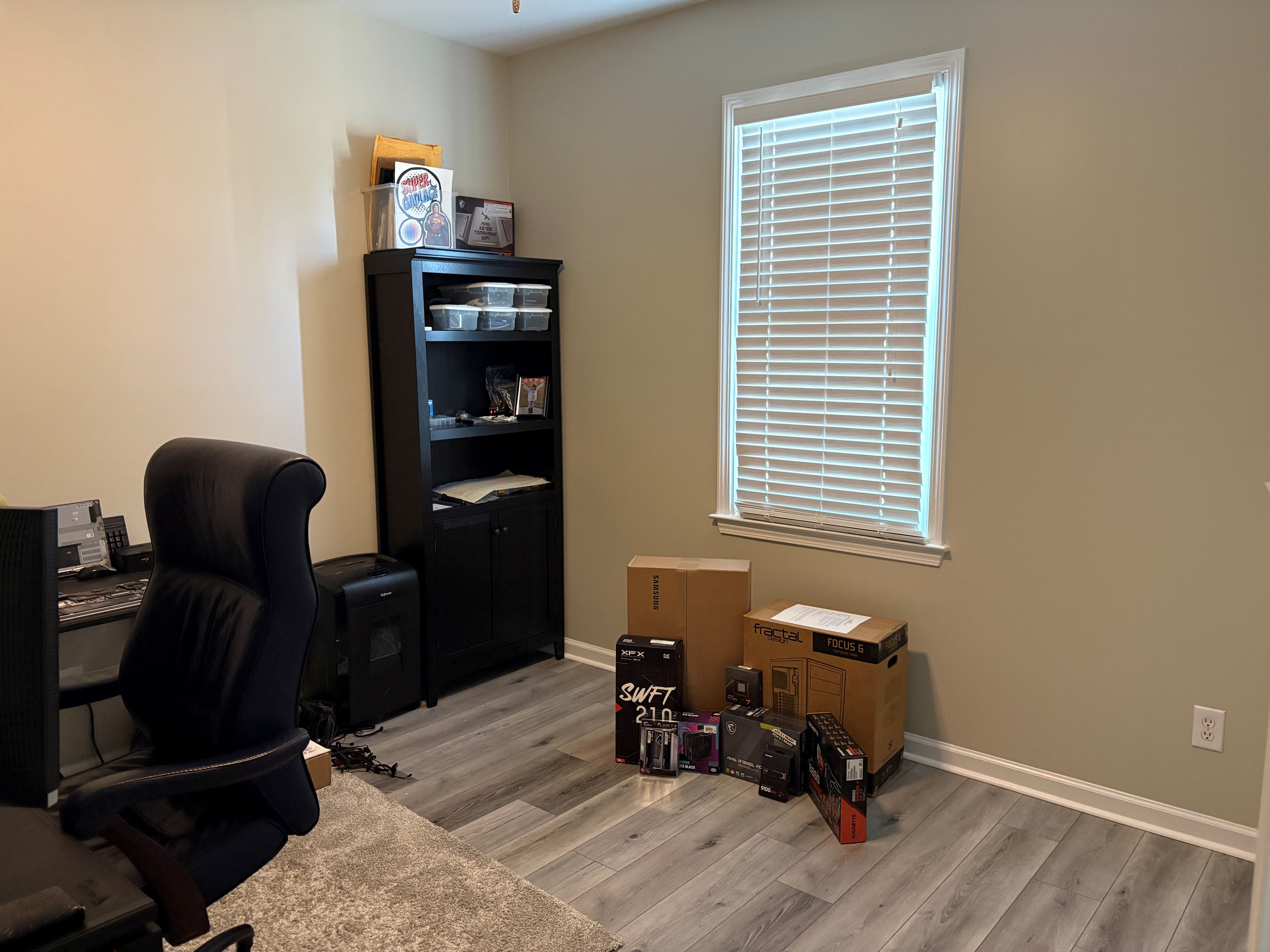 Workspace area with parts boxes and custom computer components ready for use